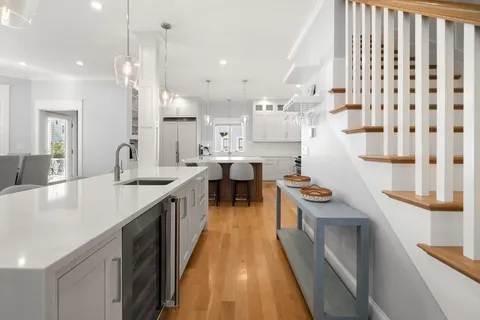 a large kitchen with kitchen island a sink a counter space and stainless steel appliances