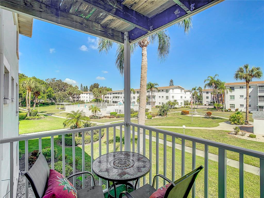 a view of a balcony with table and chairs