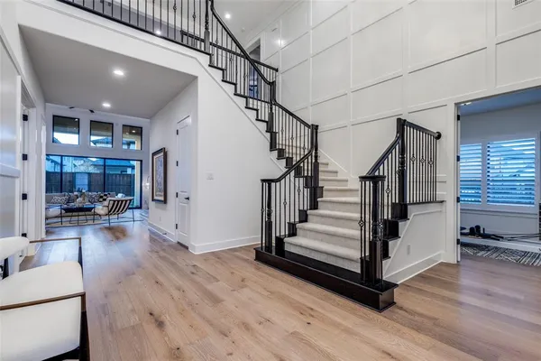 a view of entryway and hall with wooden floor