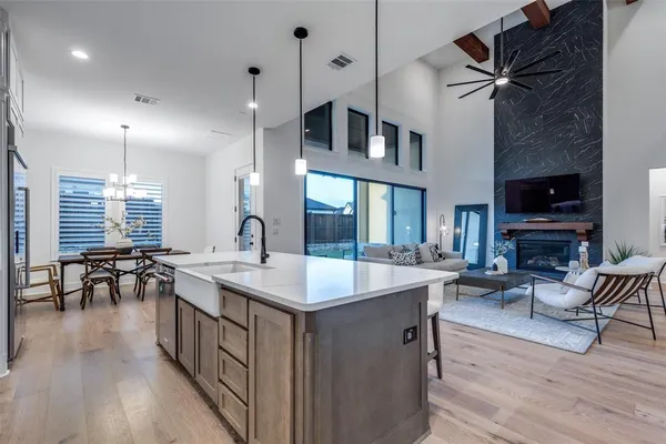 a kitchen with sink stove and cabinets