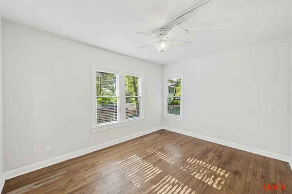 wooden floor in an empty room with a window