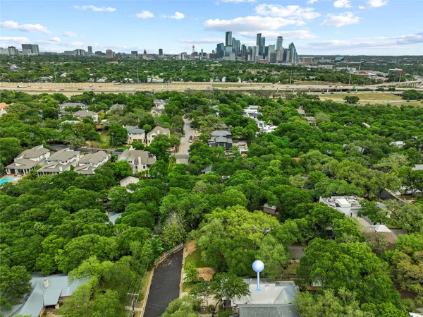 an aerial view of a houses with outdoor space and trees