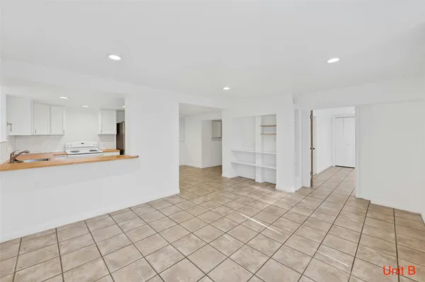 a kitchen with a sink appliances and cabinets