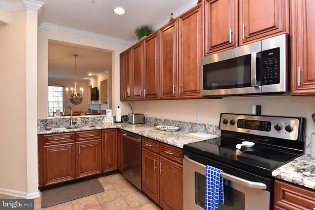 a kitchen with a sink stove and microwave