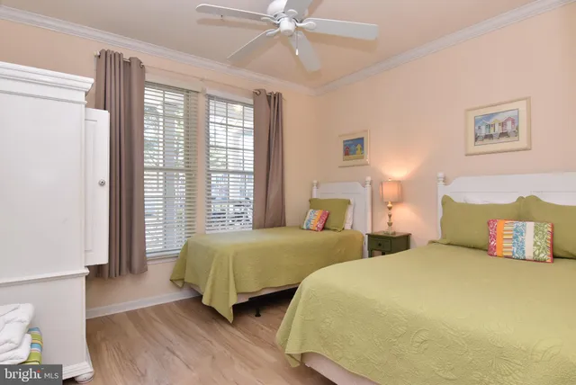 a bedroom with two beds and a chandelier