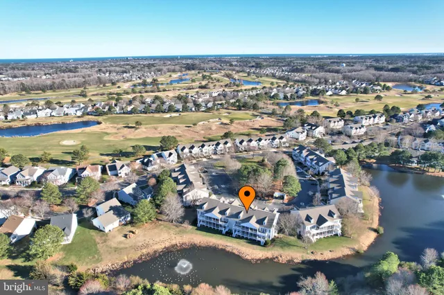 an aerial view of a house with a swimming pool and outdoor seating
