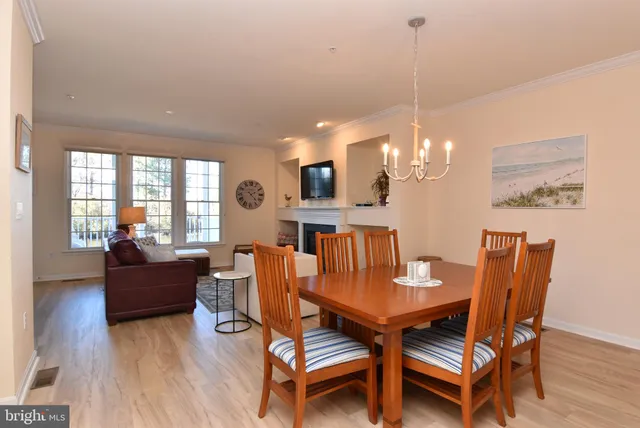 a view of a dining room with furniture wooden floor and a chandelier