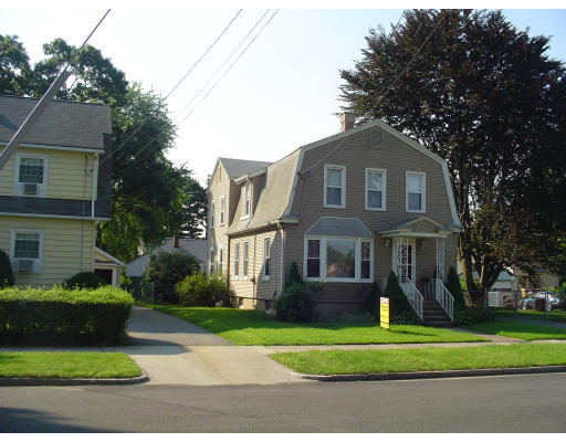 119 Farnsworth Street Springfield, MA 01107 - Photo 3 of 23 a front view of a house with a yard and trees