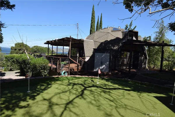 a view of a backyard with sitting area
