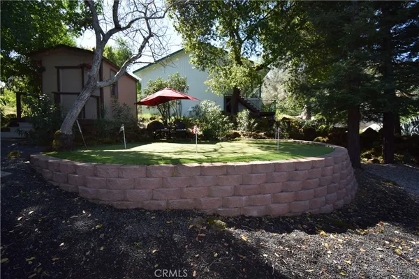 a dining room with stainless steel appliances granite countertop a dining table chairs and a refrigerator