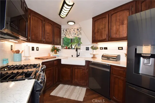 a living room with furniture flat screen tv and a large window