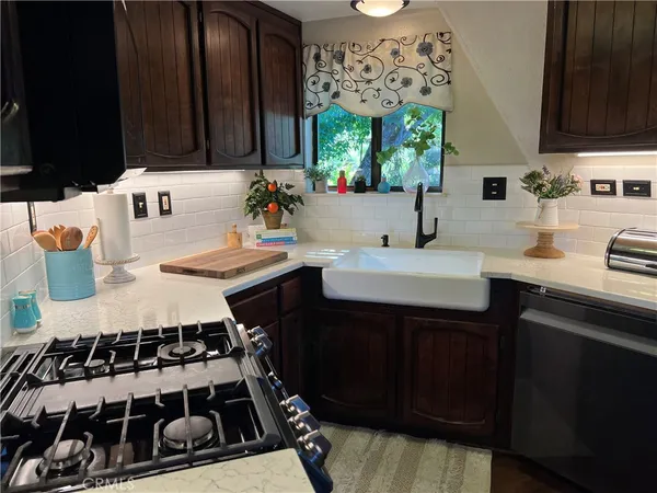 a living room with furniture a flat screen tv and a floor to ceiling window