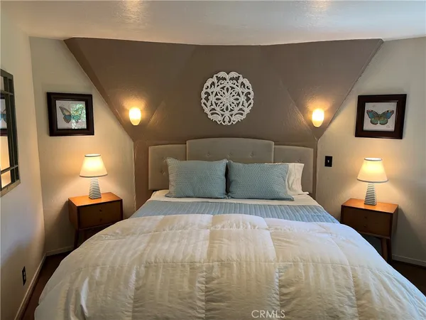 a bedroom with a bed and a dresser