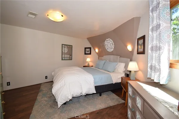 a bathroom with a sink and mirror with bathtub