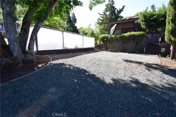 a view of a patio with table and chairs with wooden floor and fence