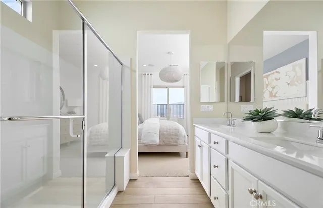 a en suite bathroom with a granite countertop sink and a mirror