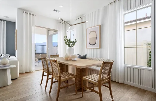 a view of a dining room with furniture window and wooden floor