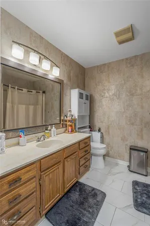 a spacious bathroom with a double vanity sink mirror and toilet