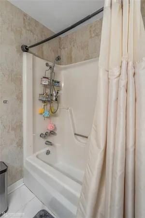 a bathroom with a shower curtain and a bathtub