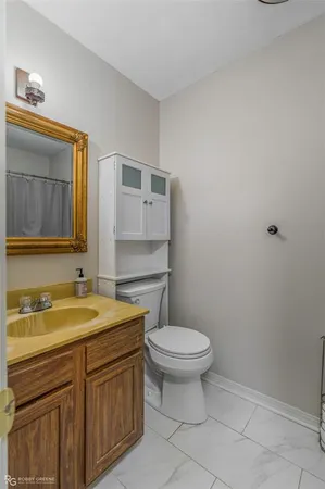 a bathroom with a sink a toilet and mirror