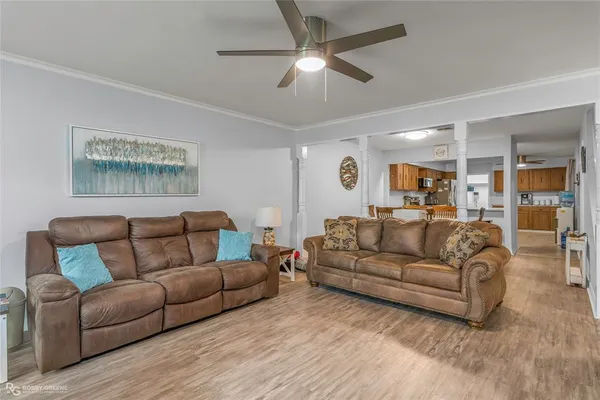 a living room with furniture and a ceiling fan