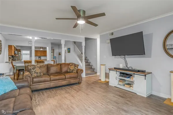 a living room with furniture and a flat screen tv