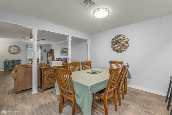 a view of a dining room with furniture and wooden floor