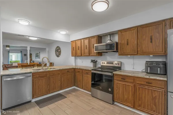 a kitchen with stainless steel appliances granite countertop a stove sink and cabinets