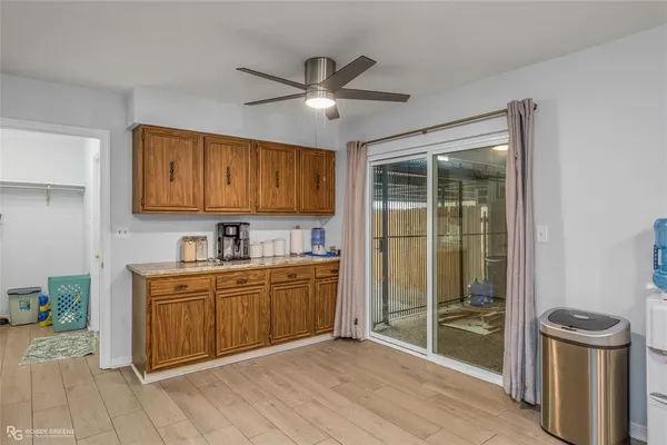 a kitchen with stainless steel appliances granite countertop a stove a sink and a refrigerator with wooden cabinets