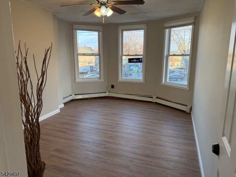 85 Holsman Street Paterson, NJ 07522 - Photo 1 of 20 an empty room with wooden floor and windows
