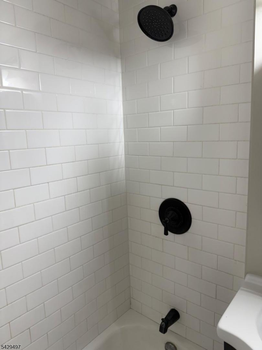 85 Holsman Street Paterson, NJ 07522 - Photo 12 of 20 a bathroom with a shower