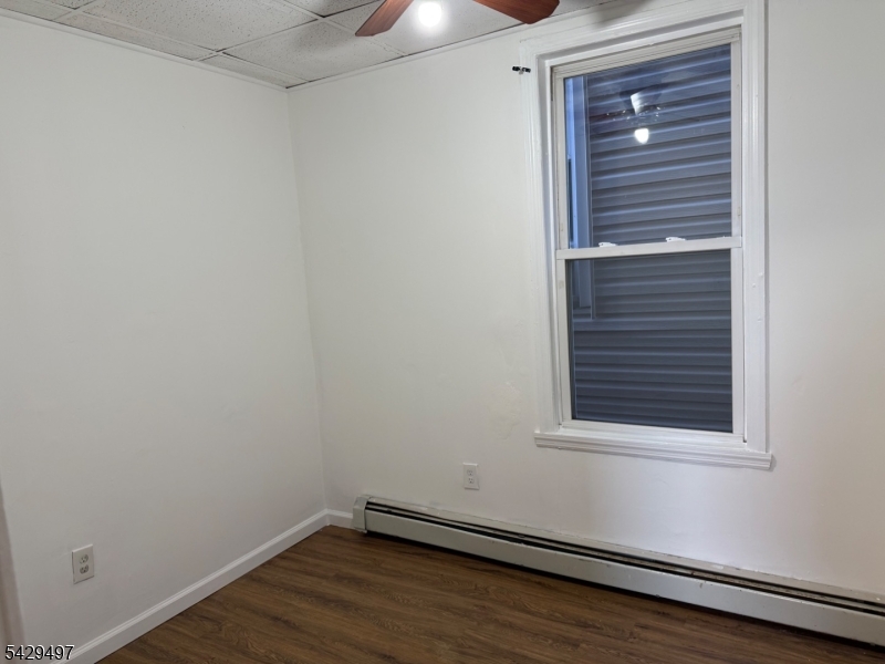 85 Holsman Street Paterson, NJ 07522 - Photo 16 of 20 a view of a small space with wooden floor and a window