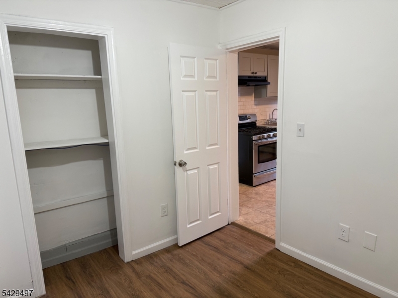 85 Holsman Street Paterson, NJ 07522 - Photo 17 of 20 a view of a kitchen with wooden floor and a refrigerator