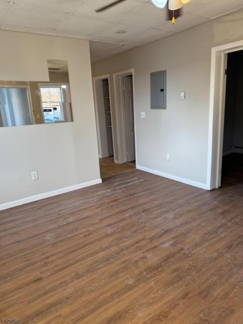 85 Holsman Street Paterson, NJ 07522 - Photo 18 of 20 an empty room with wooden floor and mirror