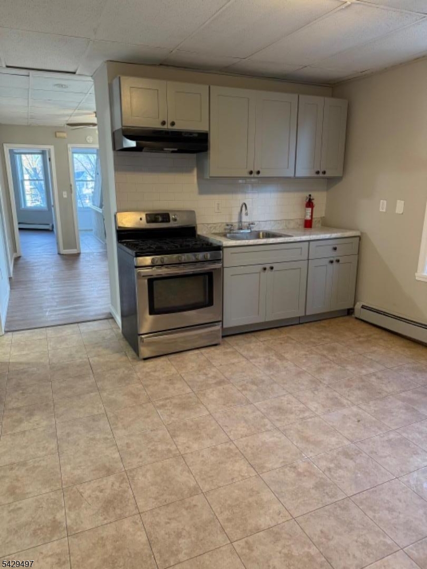 85 Holsman Street Paterson, NJ 07522 - Photo 6 of 20 a kitchen with stainless steel appliances a stove a sink and a refrigerator