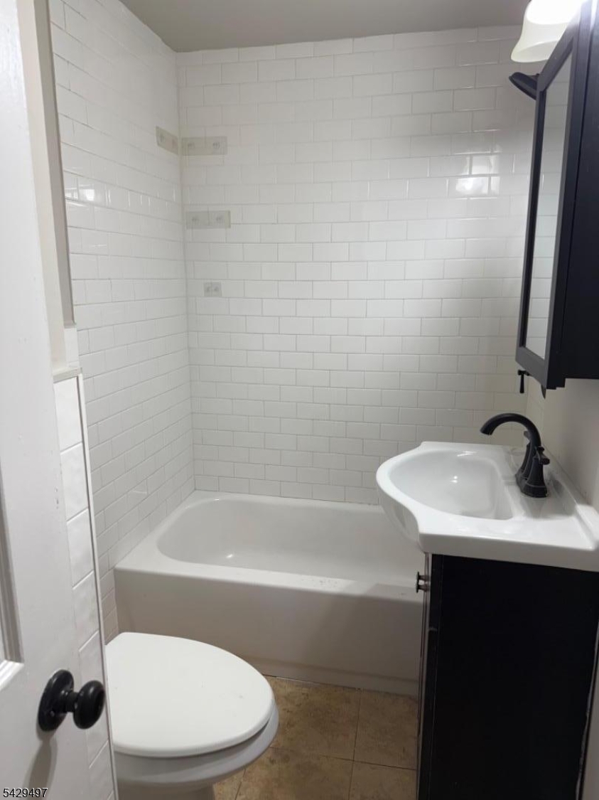 85 Holsman Street Paterson, NJ 07522 - Photo 9 of 20 a bathroom with a sink toilet and shower