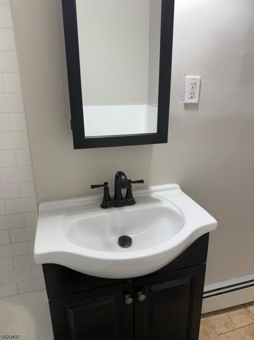 85 Holsman Street Paterson, NJ 07522 - Photo 10 of 20 a bathroom with a sink and a mirror
