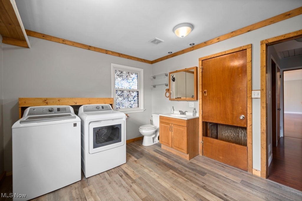 5956 Ryan Road Medina, OH 44256 - Photo 13 of 27 Laundry area and half bath with light wood-style flooring and washer and dryer