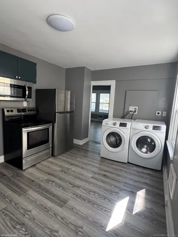 a kitchen with a stove top oven and refrigerator
