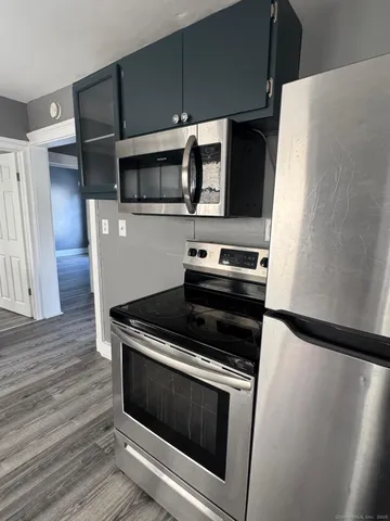 a kitchen with granite countertop a stove and a microwave