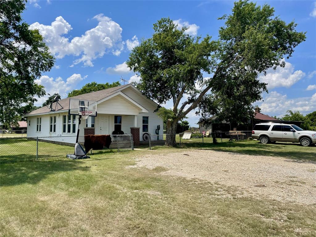 4969 Sam Bass Road Sanger, TX 76266 - Photo 1 of 5 Charming home nestled on a spacious lot with mature trees.