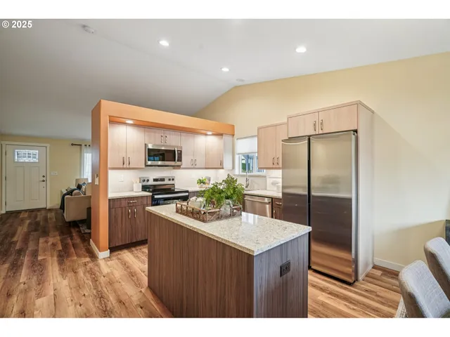 a kitchen with stainless steel appliances a refrigerator and a stove