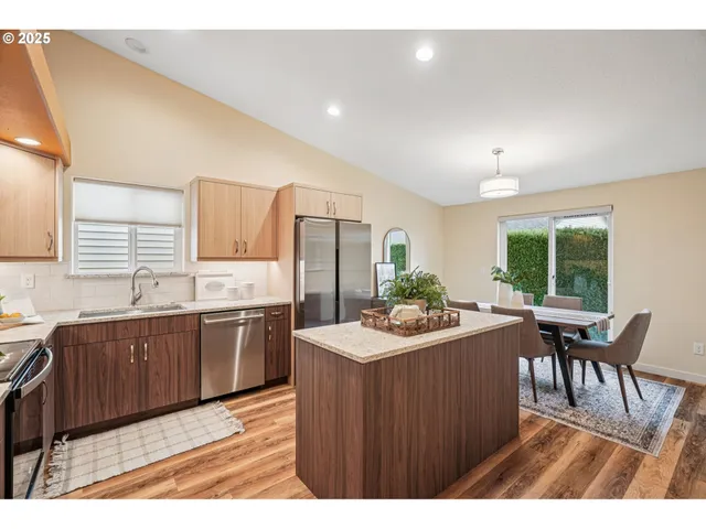 a kitchen with a sink stove and dining table