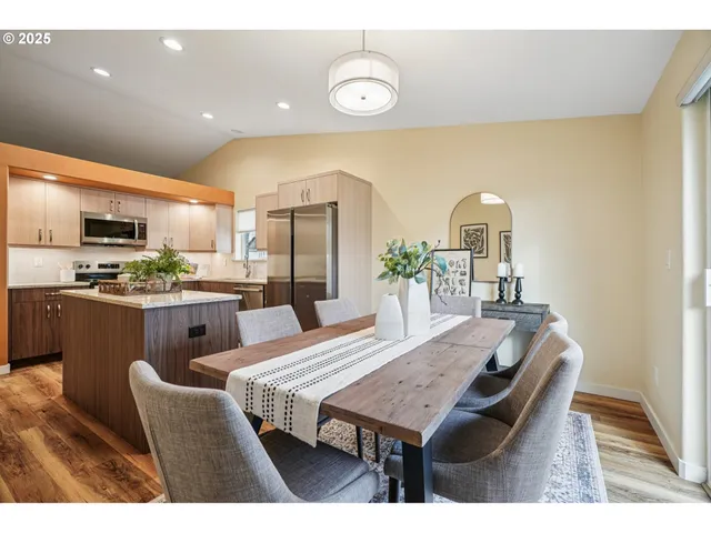 a dining room with furniture a window and kitchen view