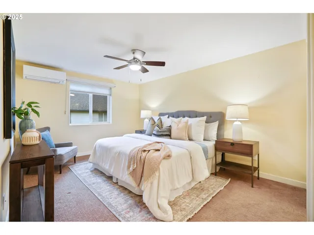 a spacious bedroom with a bed a table and chair