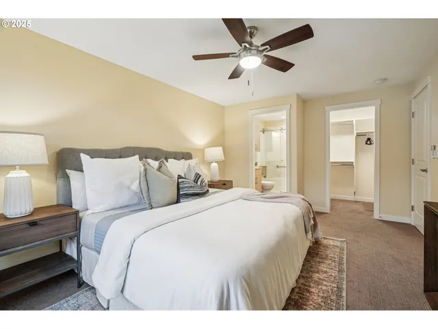 a spacious bedroom with a bed and a chandelier