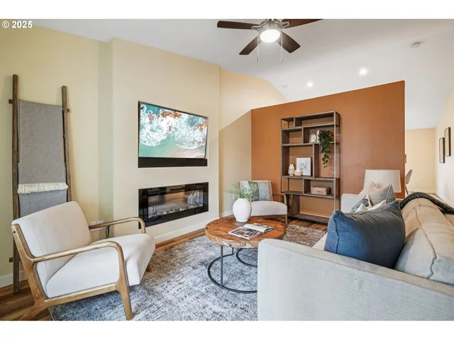 a living room with furniture a fireplace and a flat screen tv