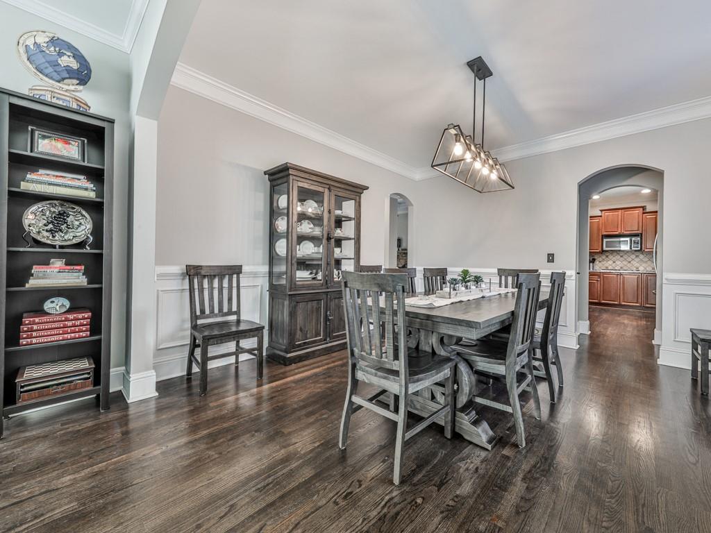 619 Riverbend Way Canton, GA 30114 - Photo 12 of 76 a view of a dining room with furniture wooden floor and chandelier