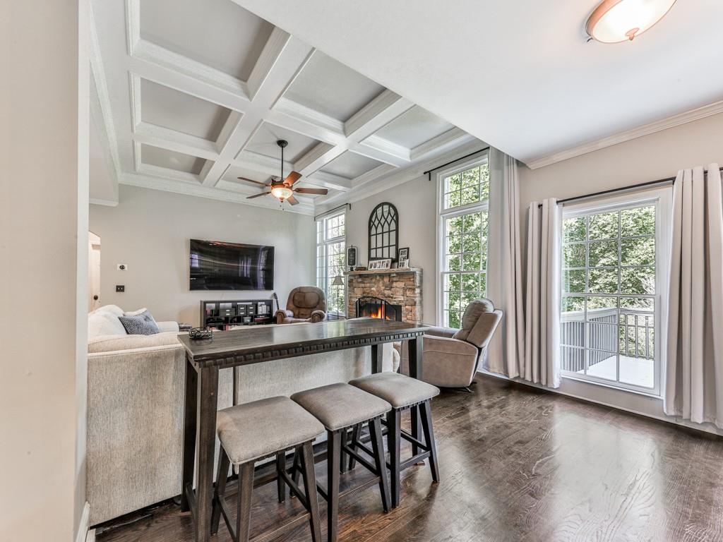 619 Riverbend Way Canton, GA 30114 - Photo 13 of 76 a living room with furniture a flat screen tv and a large window