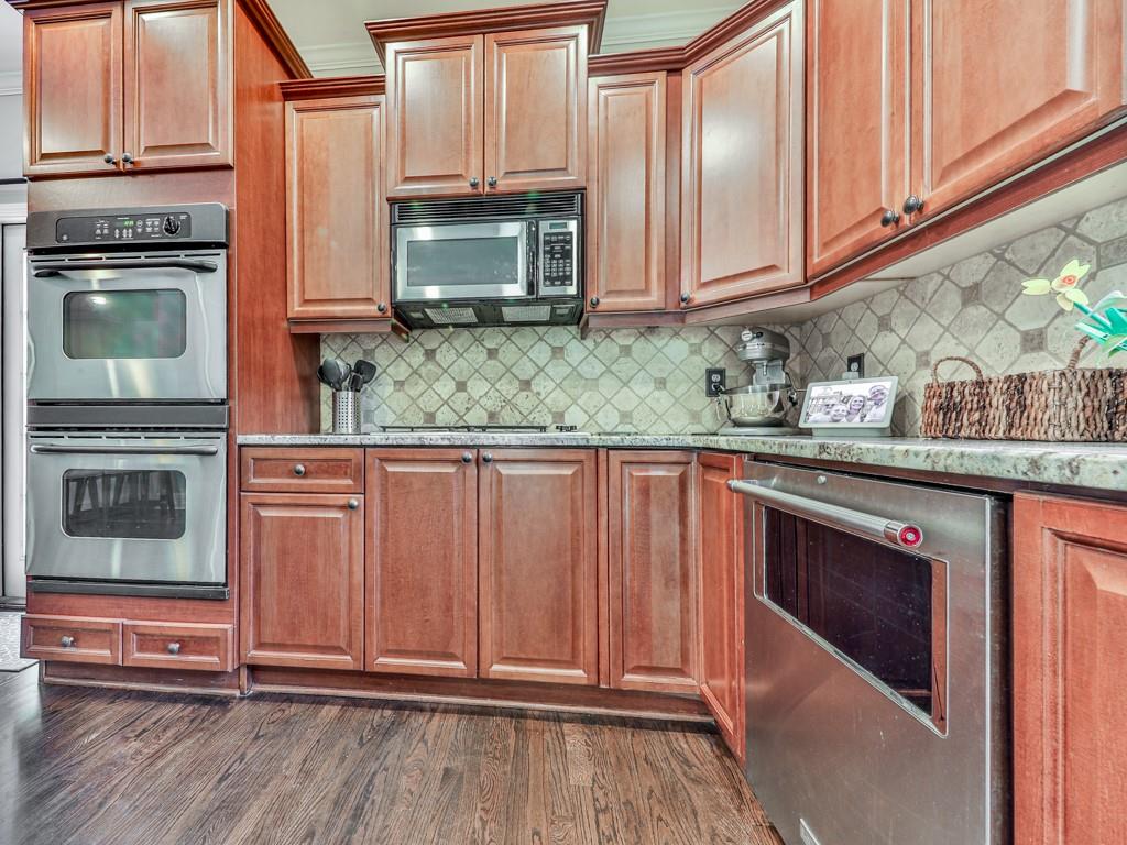 619 Riverbend Way Canton, GA 30114 - Photo 17 of 76 a kitchen with stainless steel appliances granite countertop a stove microwave and cabinets